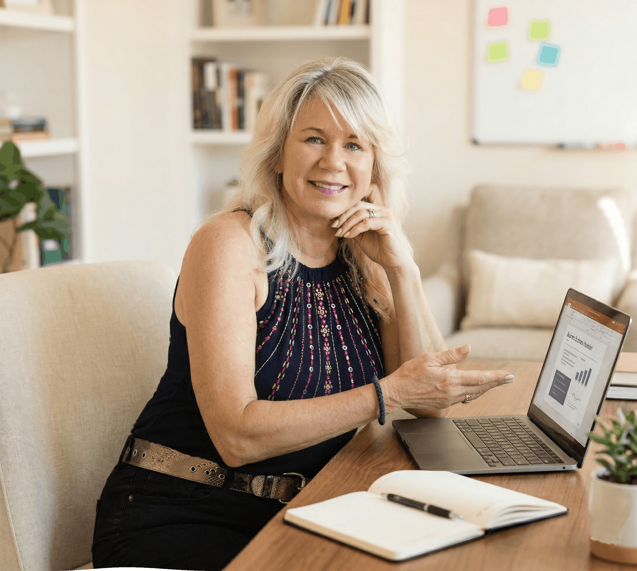 Janice is a warm business consultant in her early 60s with shoulder-length blonde hair, sitting at a desk in a bright, welcoming office